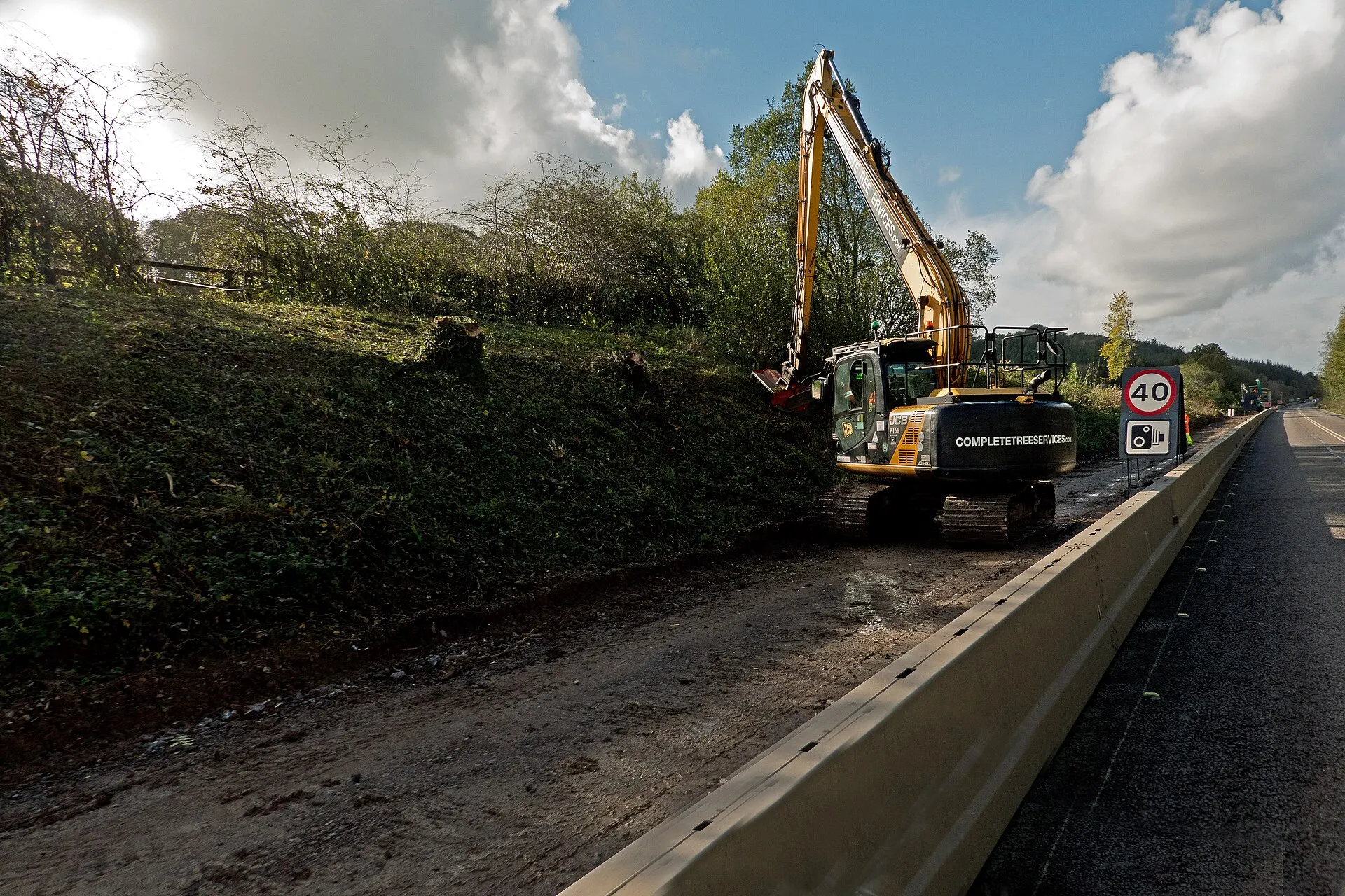 Excavator clearing brush and trees from a wooded lot in Benton County, Arkansas